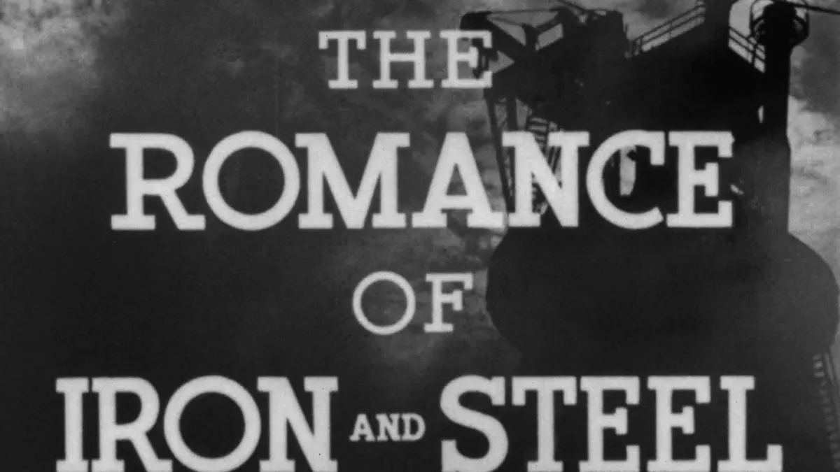 A film frame with the words The Romance of Iron and Steel set in white capitals across four lines over a dark silhouette of a steelworks.